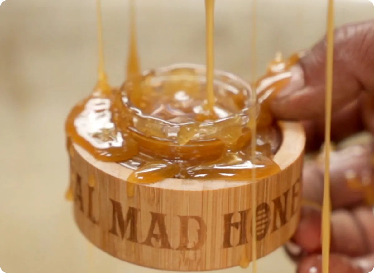 Mad honey pouring from a jar