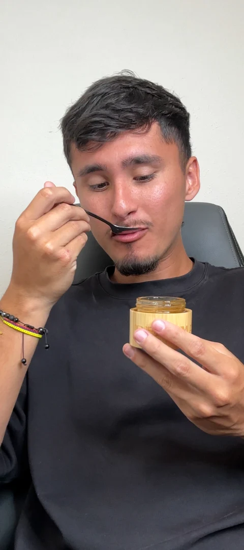 Customer tasting Real Mad Honey from a spoon