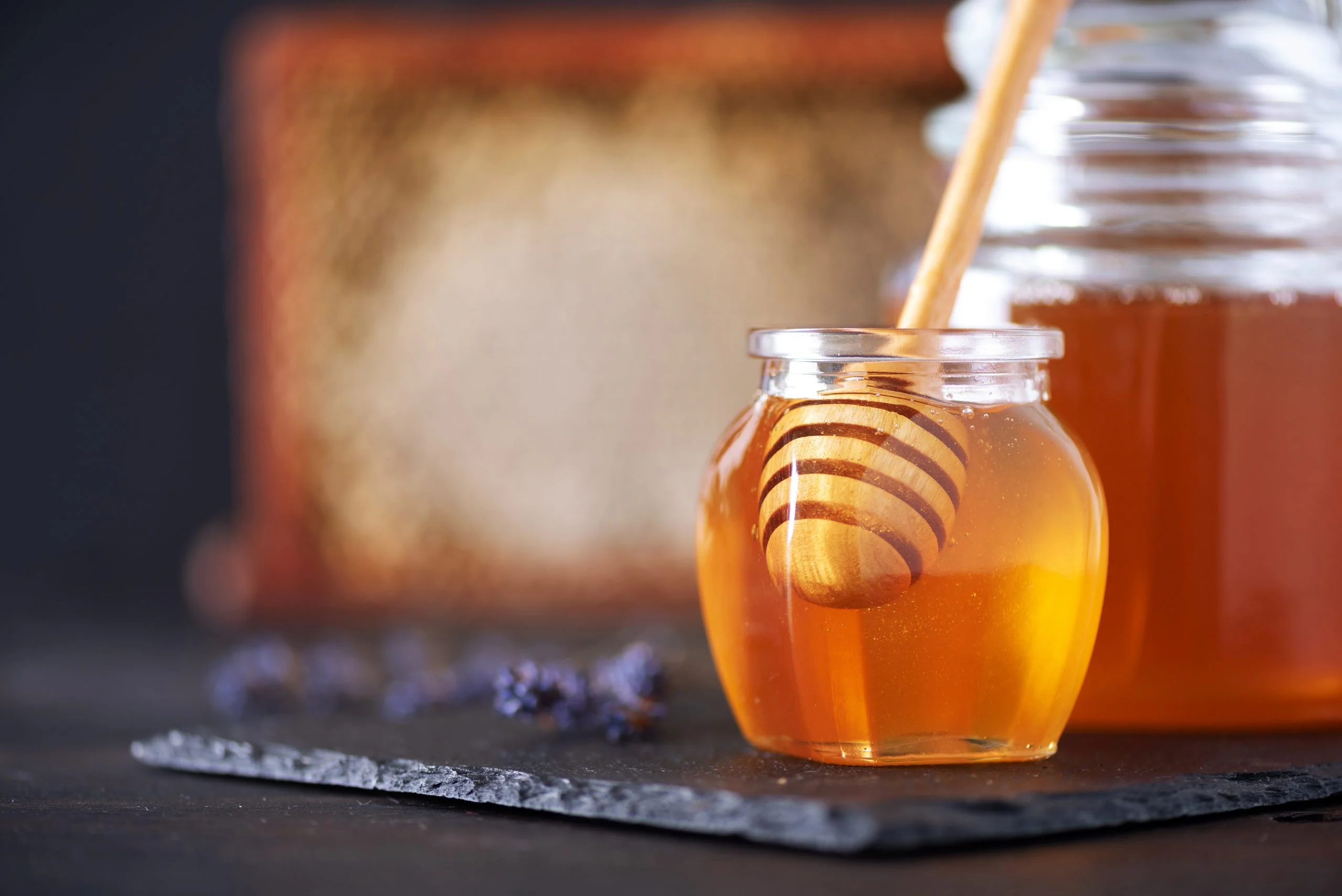 Jar of mad honey with a wooden dipper